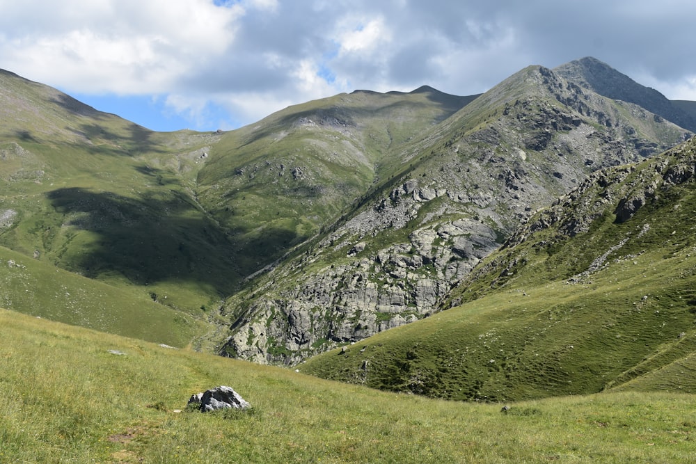 green grass field and mountain during daytime