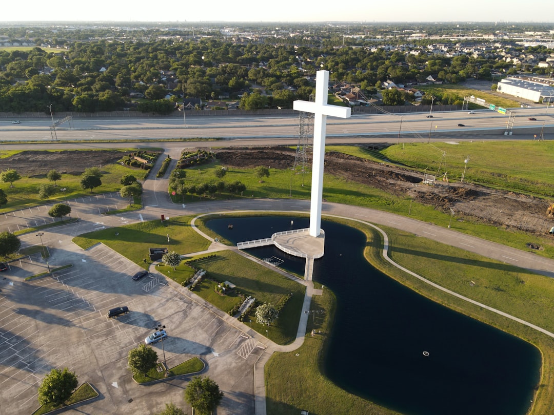 white cross on green grass field during daytime