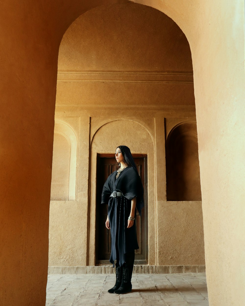 woman in black dress standing on hallway