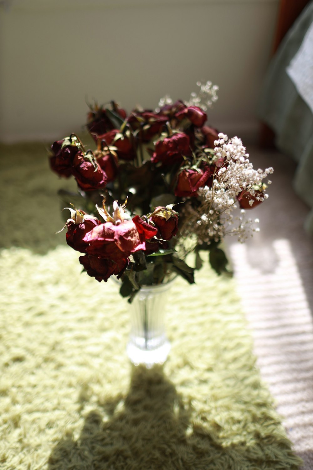 red roses in clear glass vase