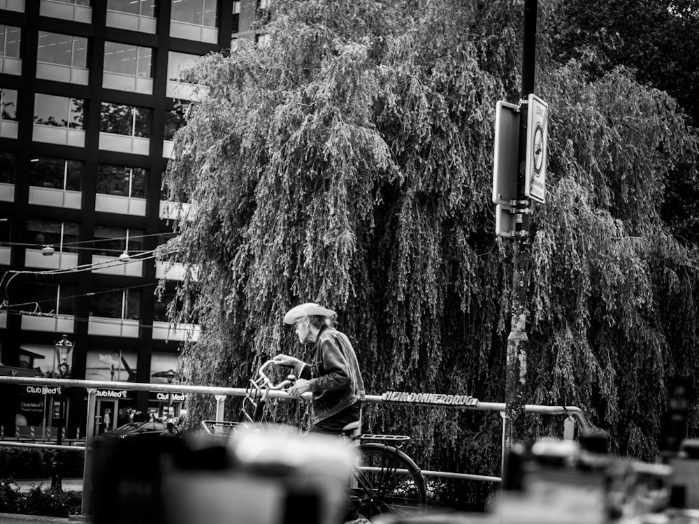 grayscale photo of bicycle near trees