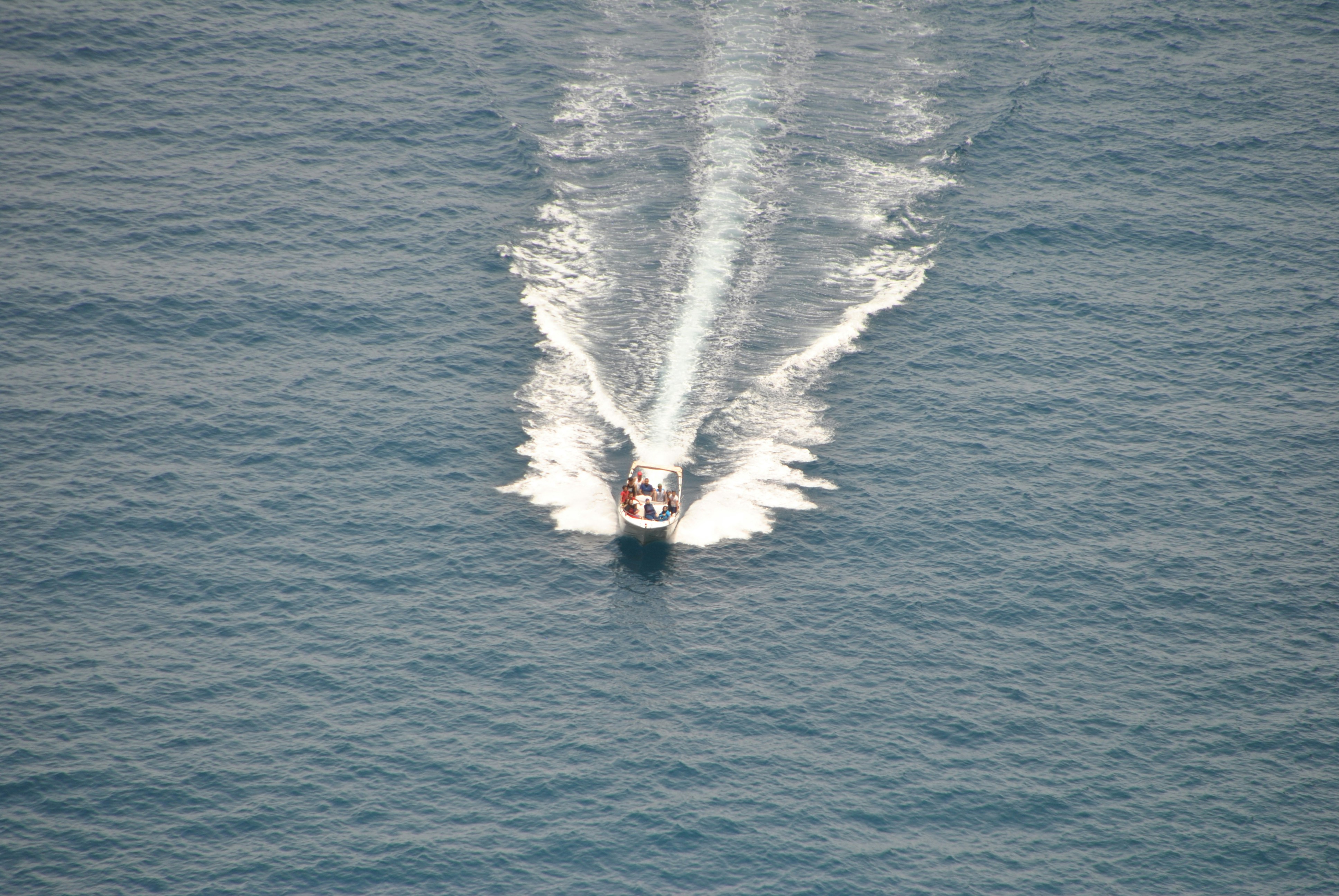 person surfing on sea waves during daytime