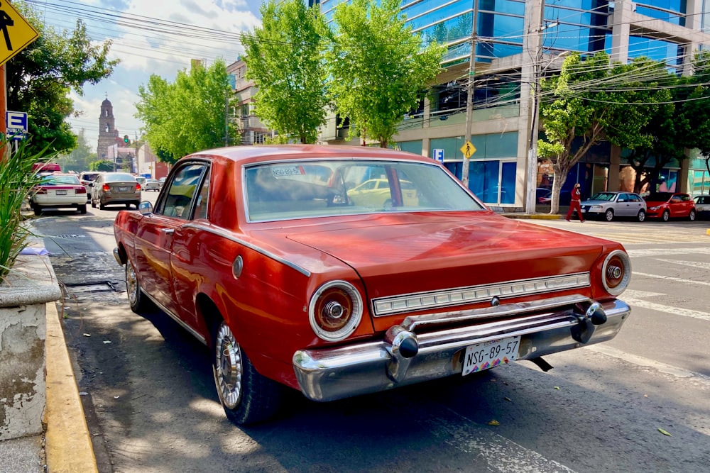 red classic car parked on street during daytime