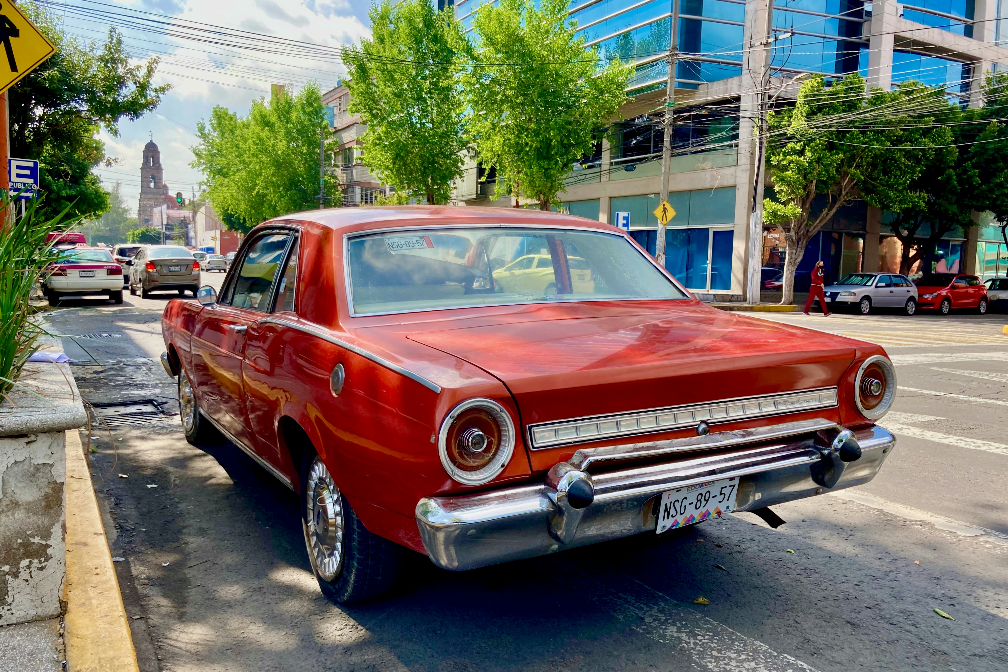 red classic car parked on street during daytime