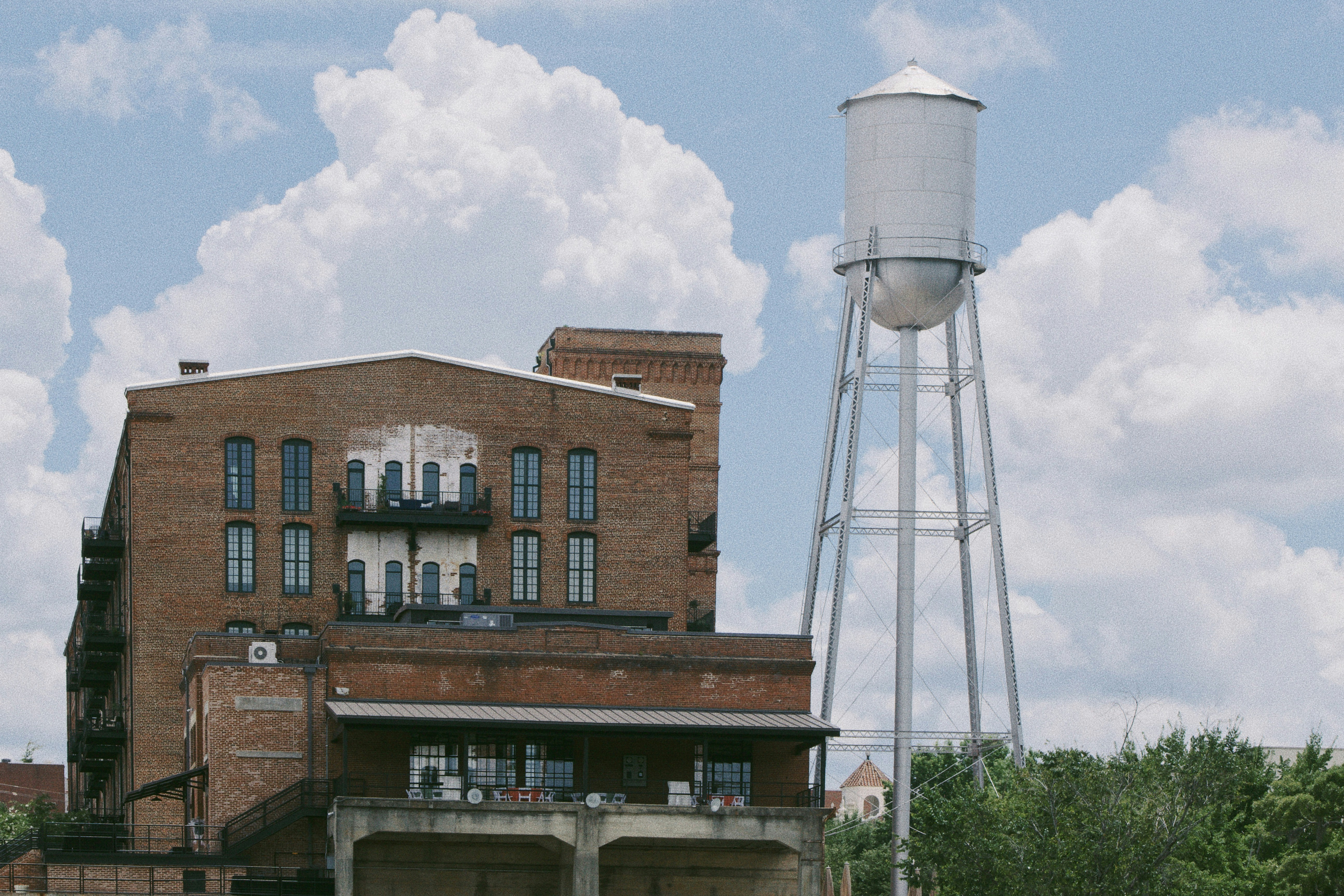 brown concrete building under white clouds during daytime