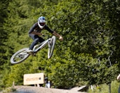 man in black helmet riding bicycle during daytime