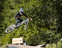 man in black helmet riding bicycle during daytime