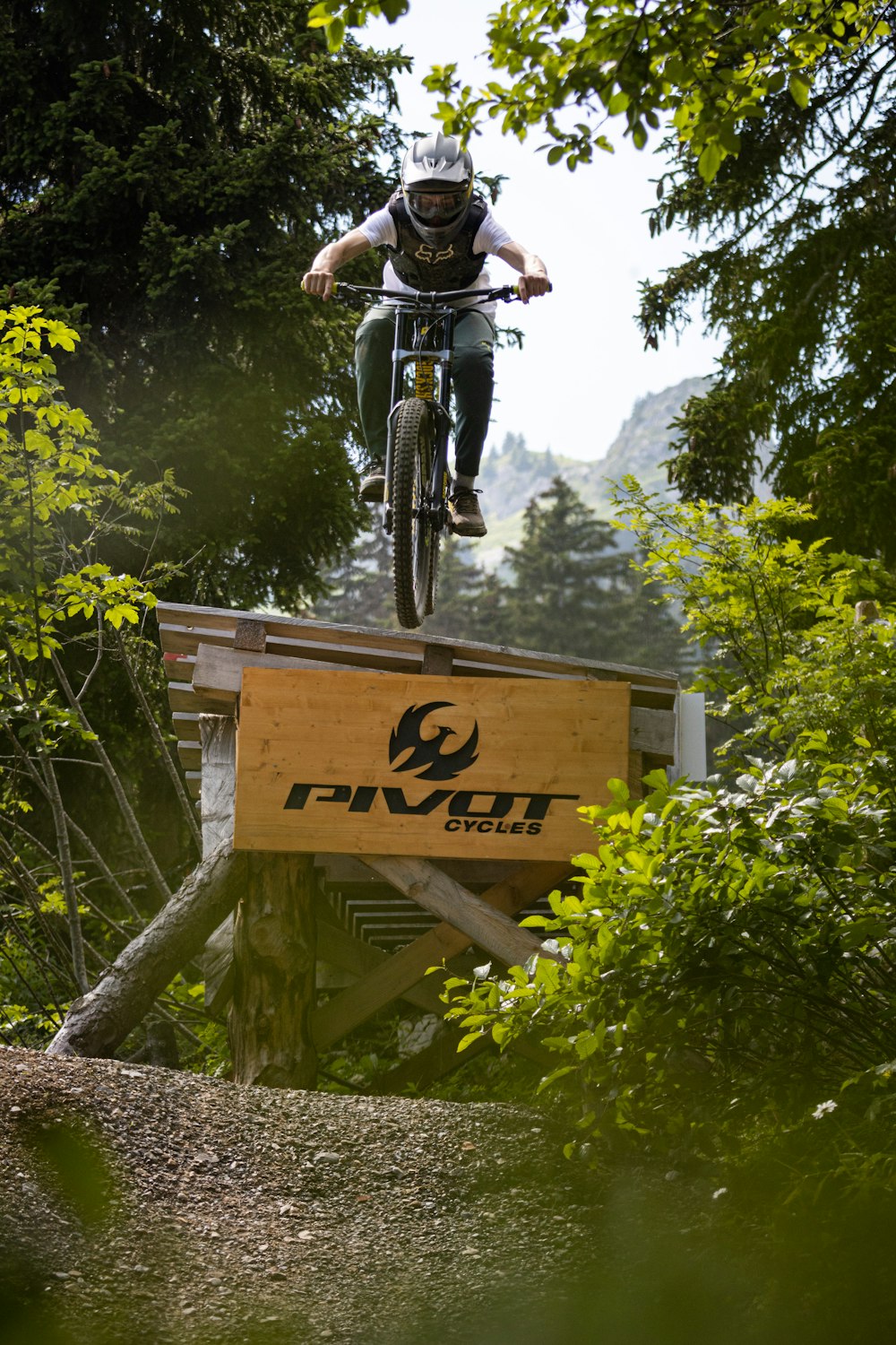 man in black jacket riding bicycle on brown wooden crate