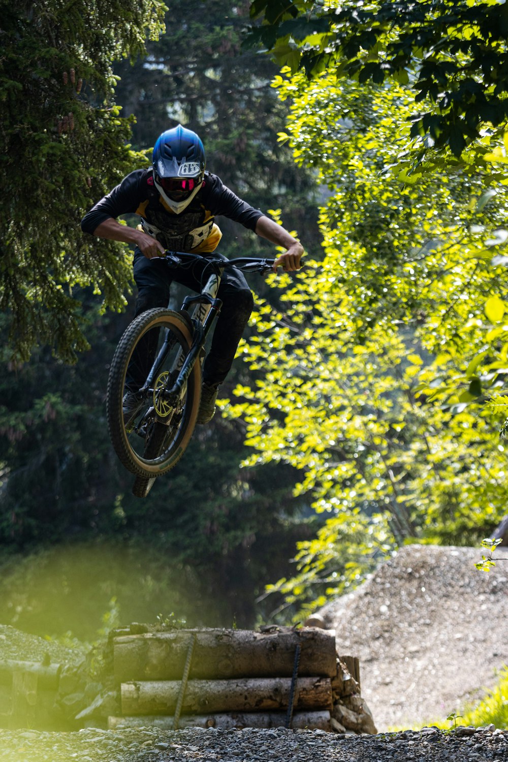 man in black helmet riding on black motocross dirt bike