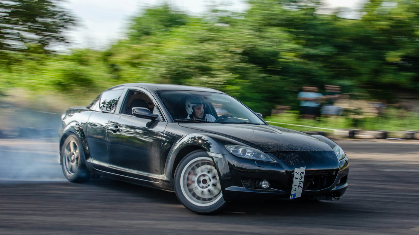 Black sports car on a road during daytime