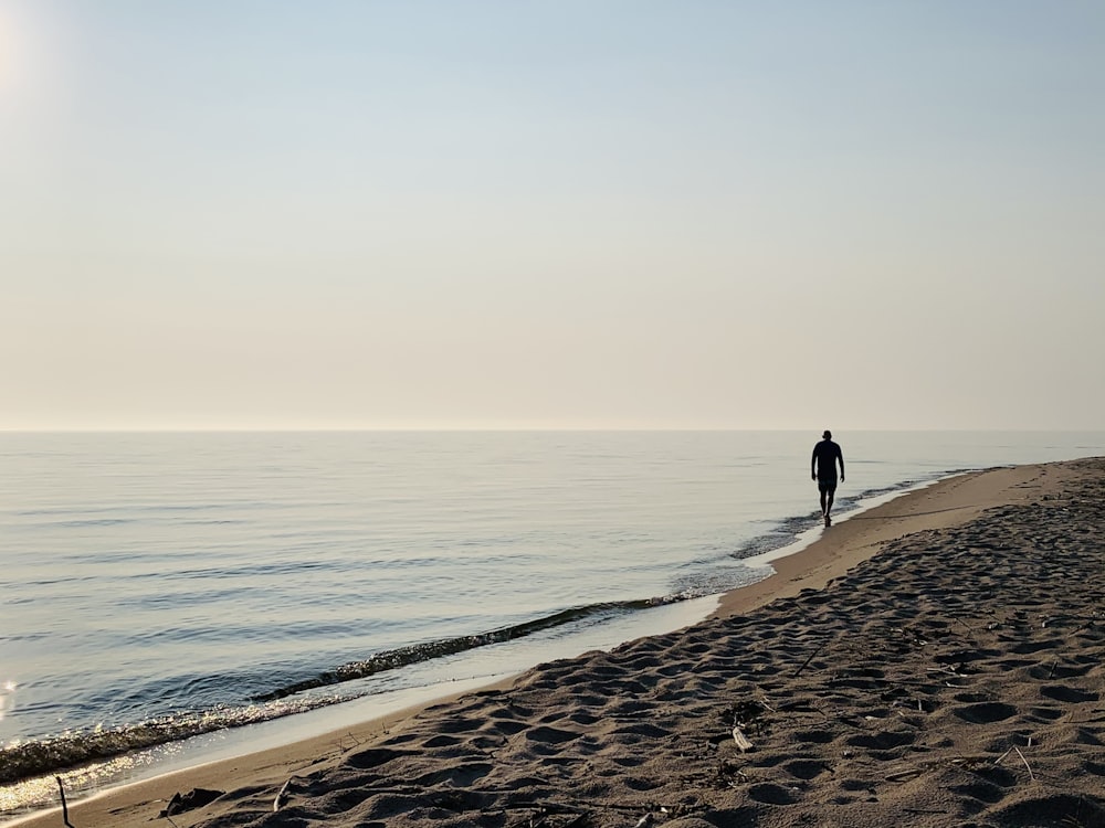 person walking on beach during daytime