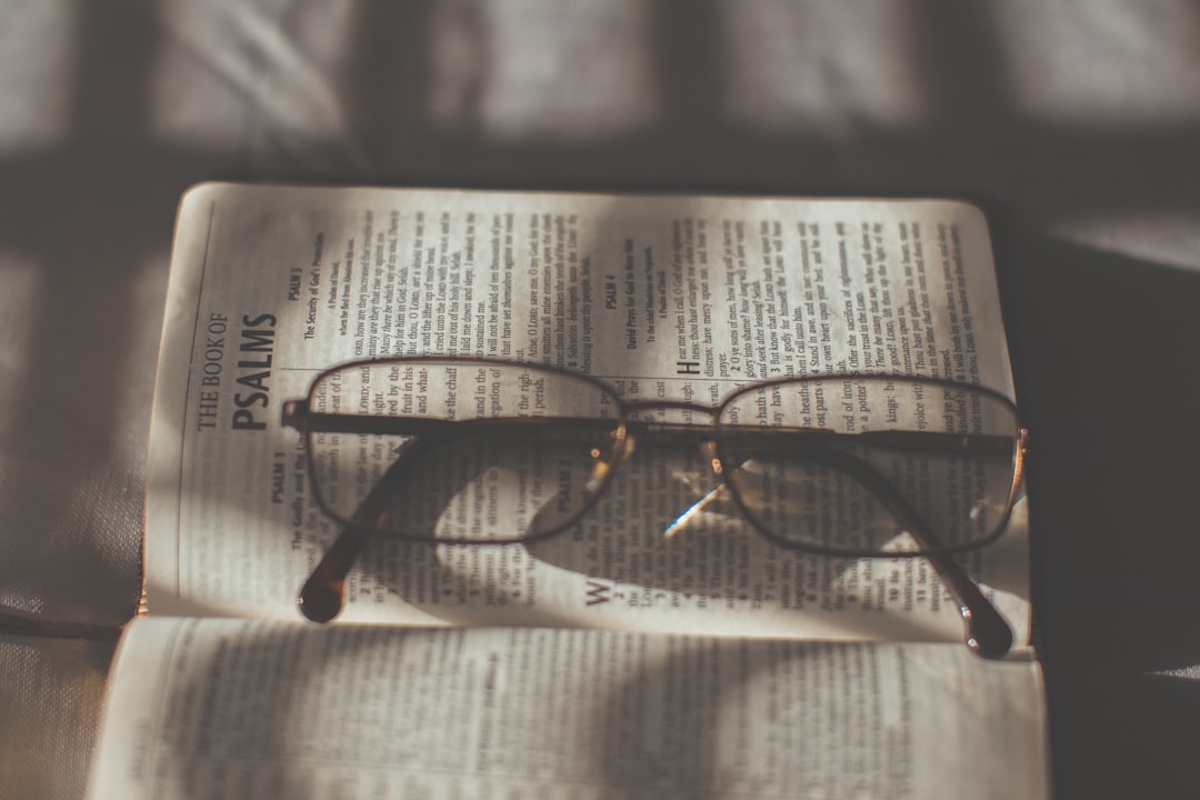 black framed eyeglasses on book page