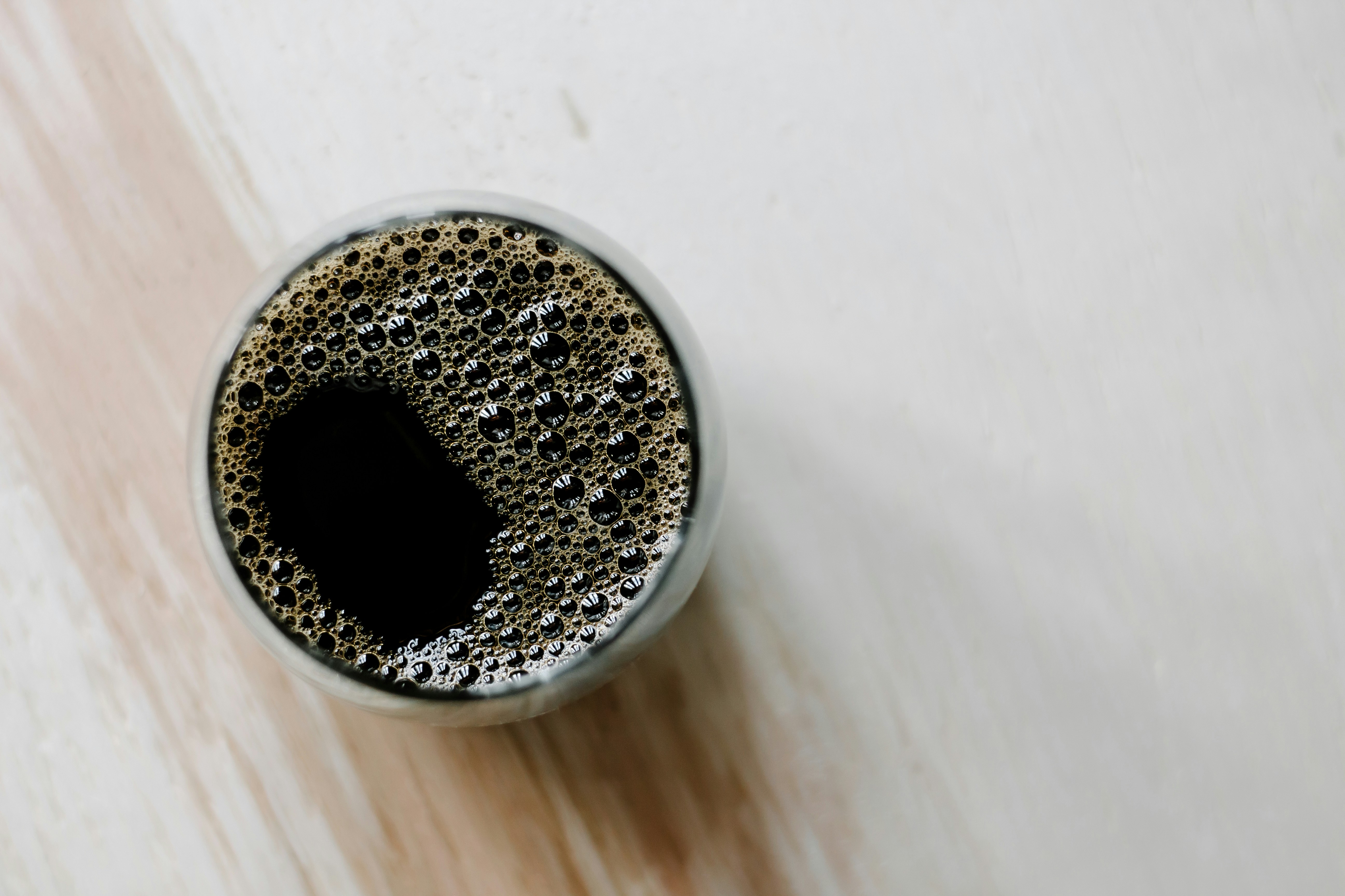 Foamy coffee in a glass, from above