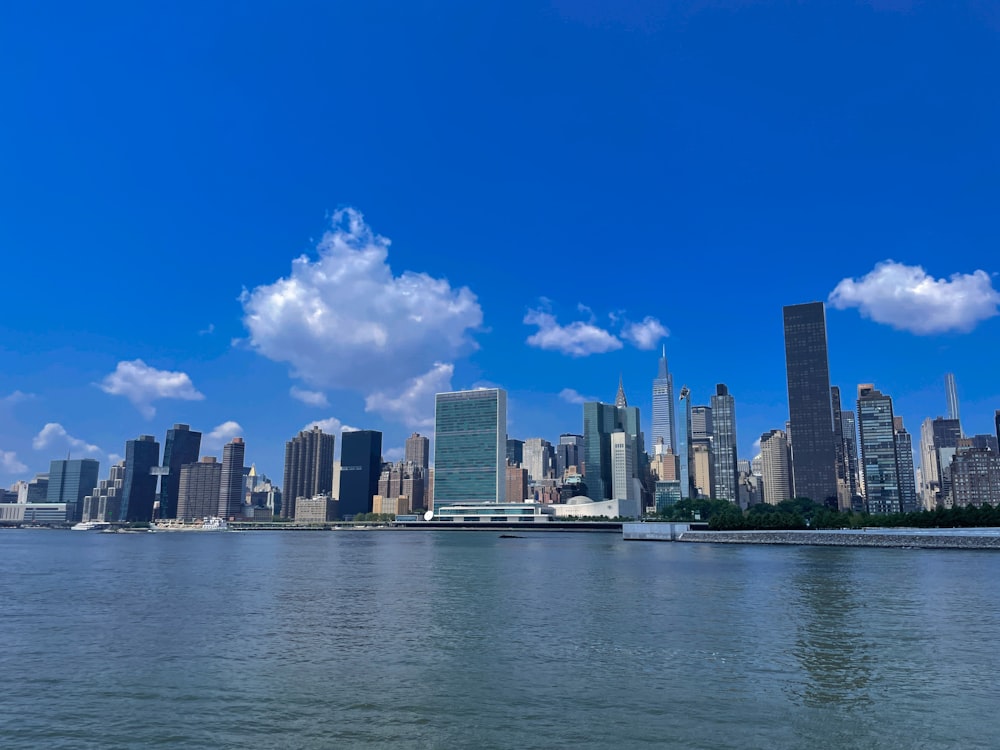 city skyline across body of water during daytime