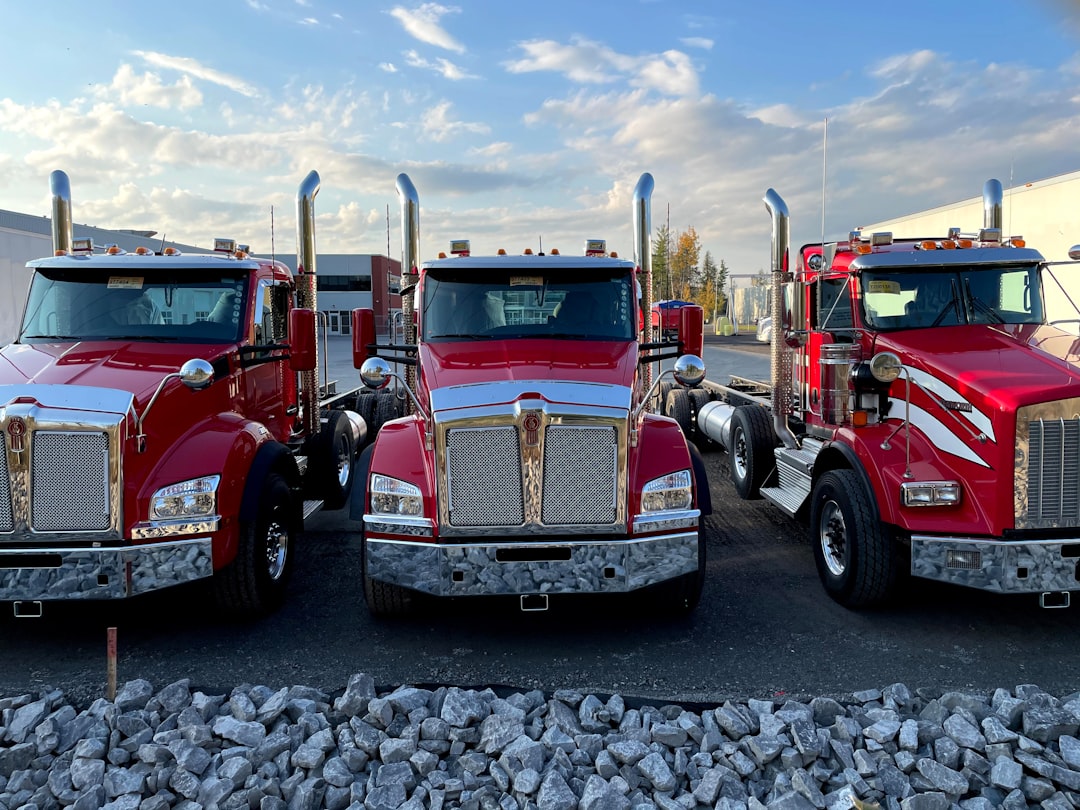 red and white truck on gray concrete pavement during daytime