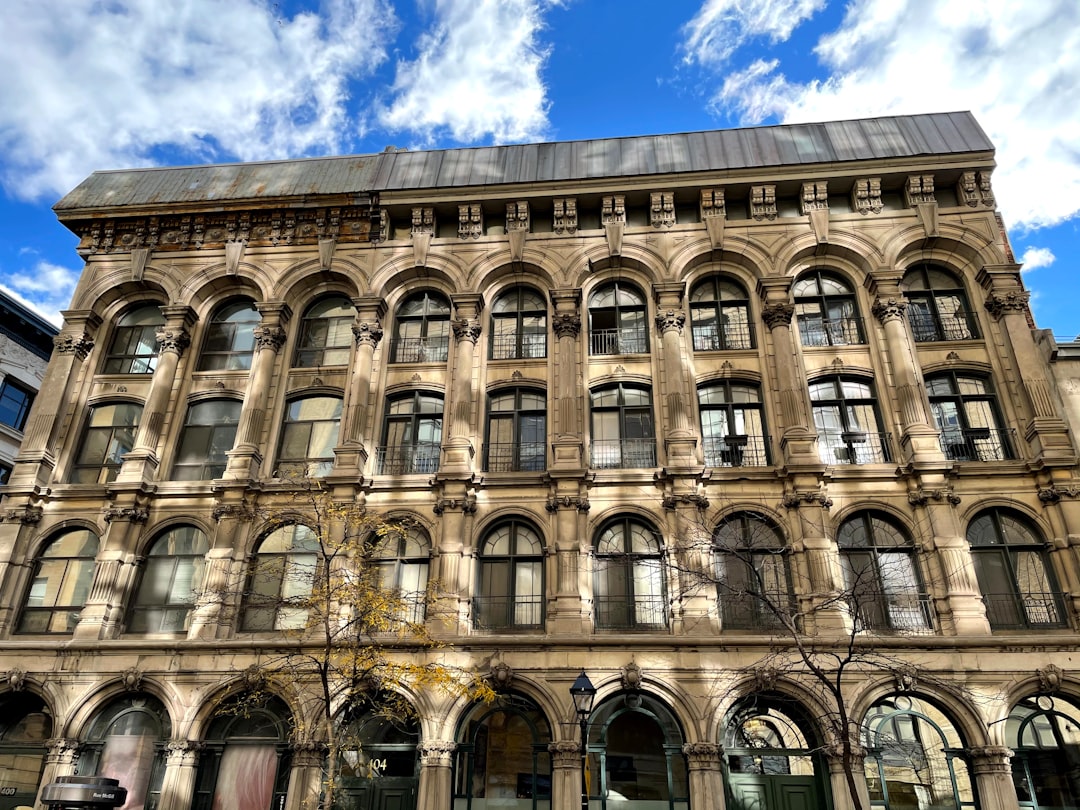 brown concrete building under blue sky and white clouds during daytime