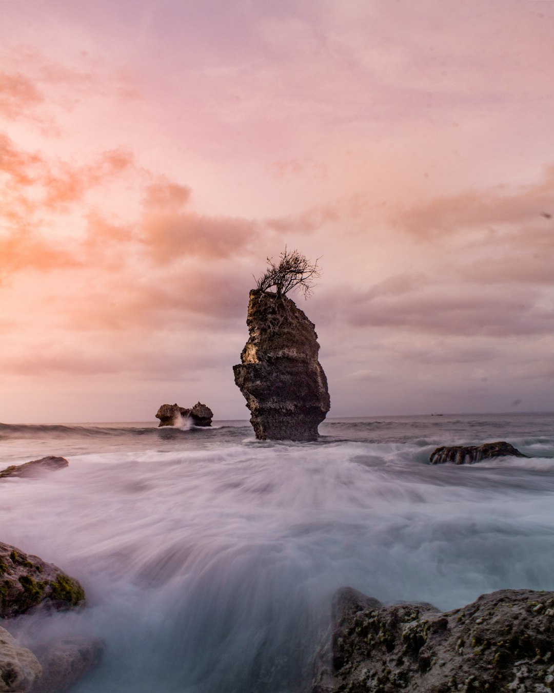 brown rock formation on sea water during daytime