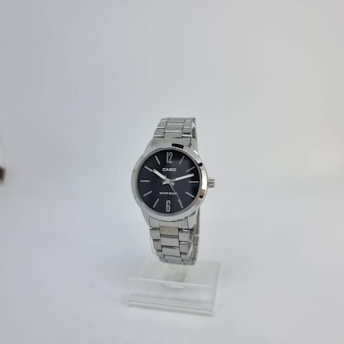 A silver wristwatch with a round black dial is displayed on a clear stand. The dial has a minimalist design with silver hour markers at 12 and 6, and two simple silver hands. The watch displays the brand name and water resistance feature on the dial.