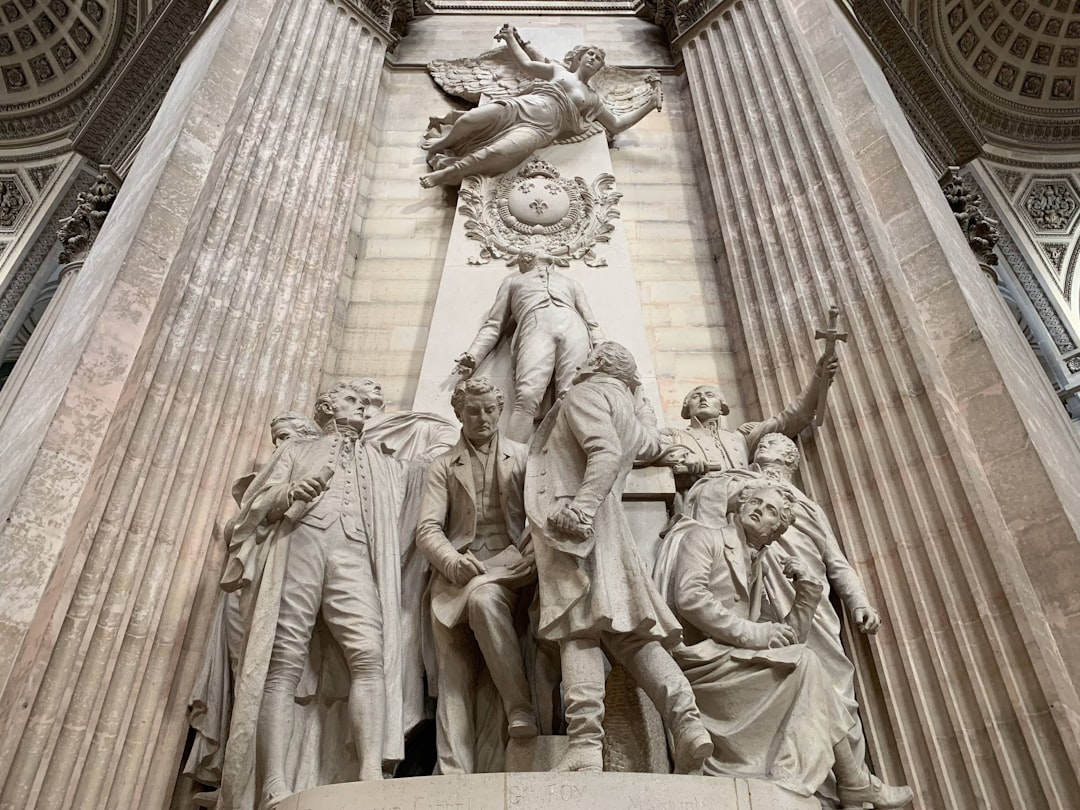 man and woman statue on top of building