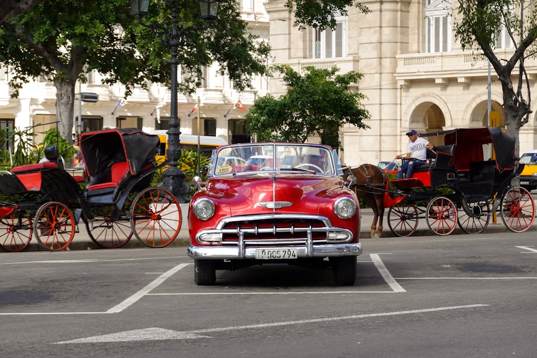 red classic car on road during daytime