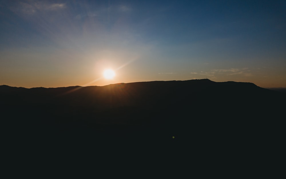 sun over the mountain during daytime