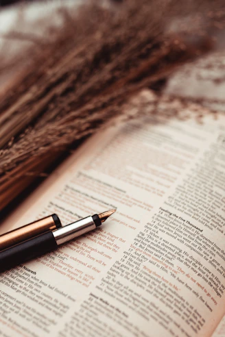 a pen sitting on top of an open book