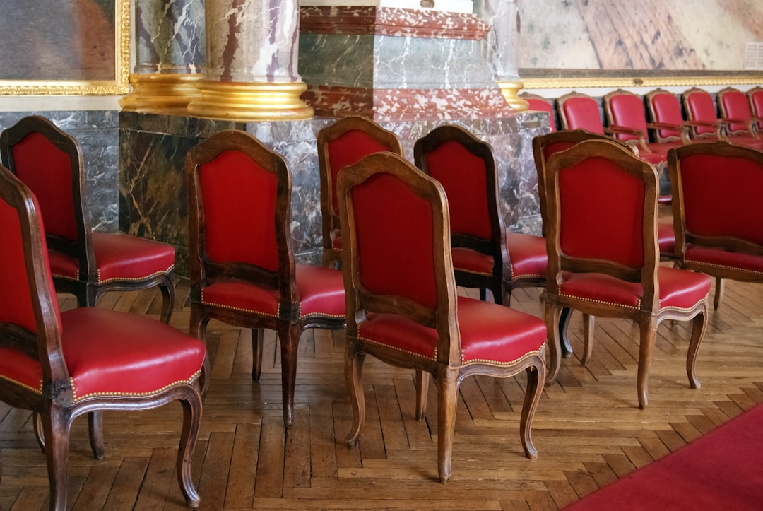 red padded chair near white wall