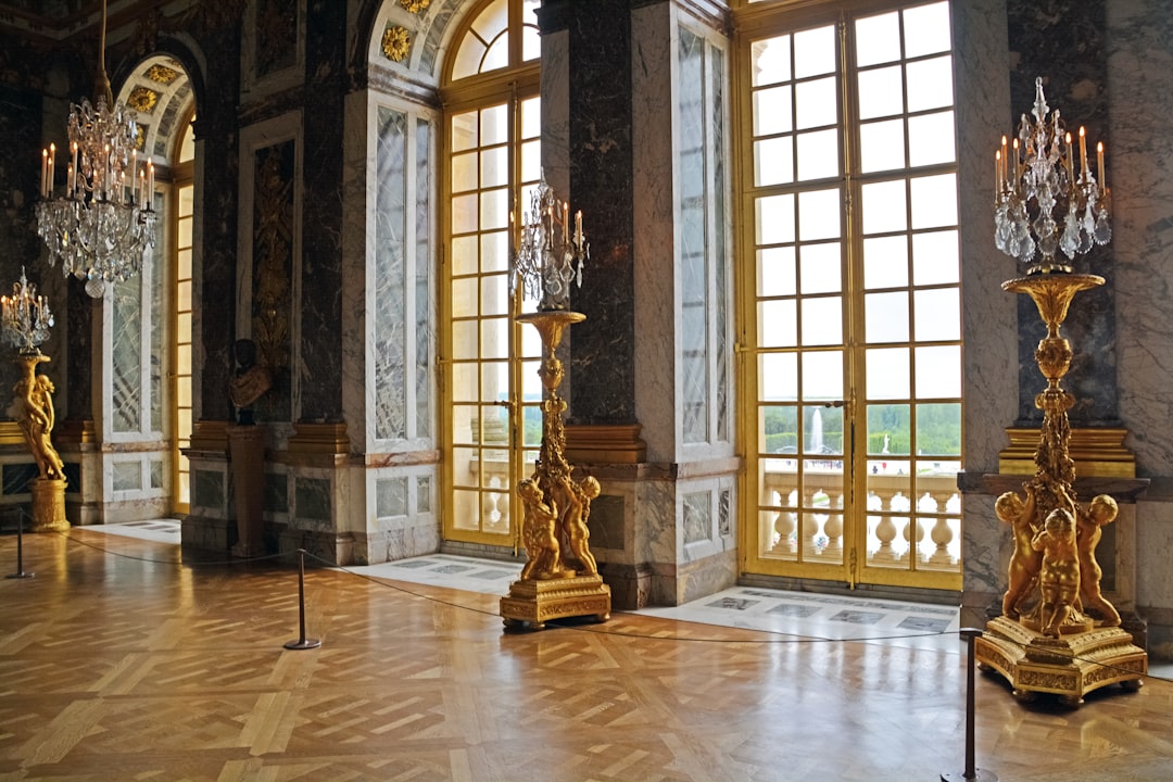 gold statue in front of brown wooden framed glass window