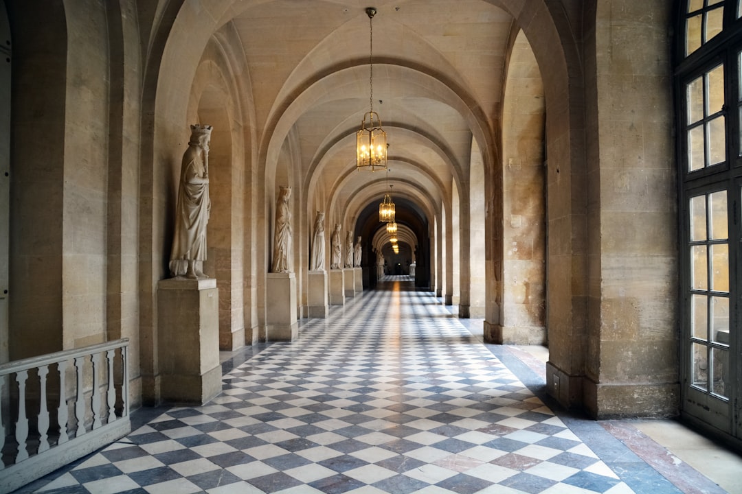 person walking on gray and white floor tiles