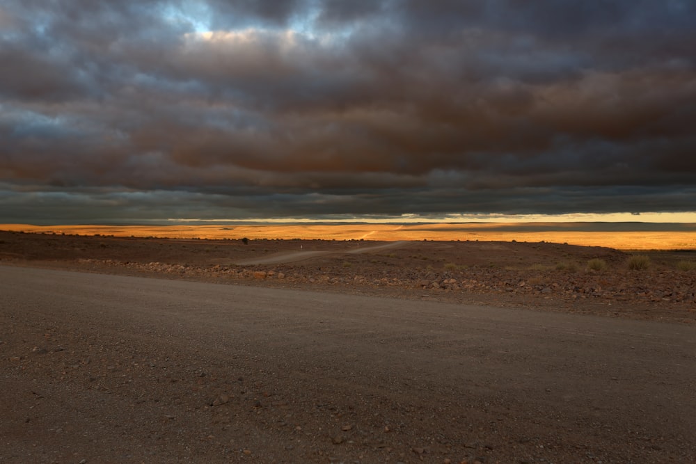 brown sand under cloudy sky during daytime