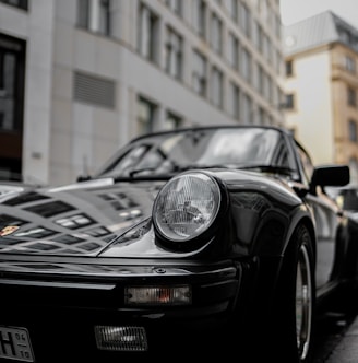 black porsche 911 parked near building during daytime