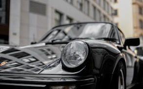 black porsche 911 parked near building during daytime