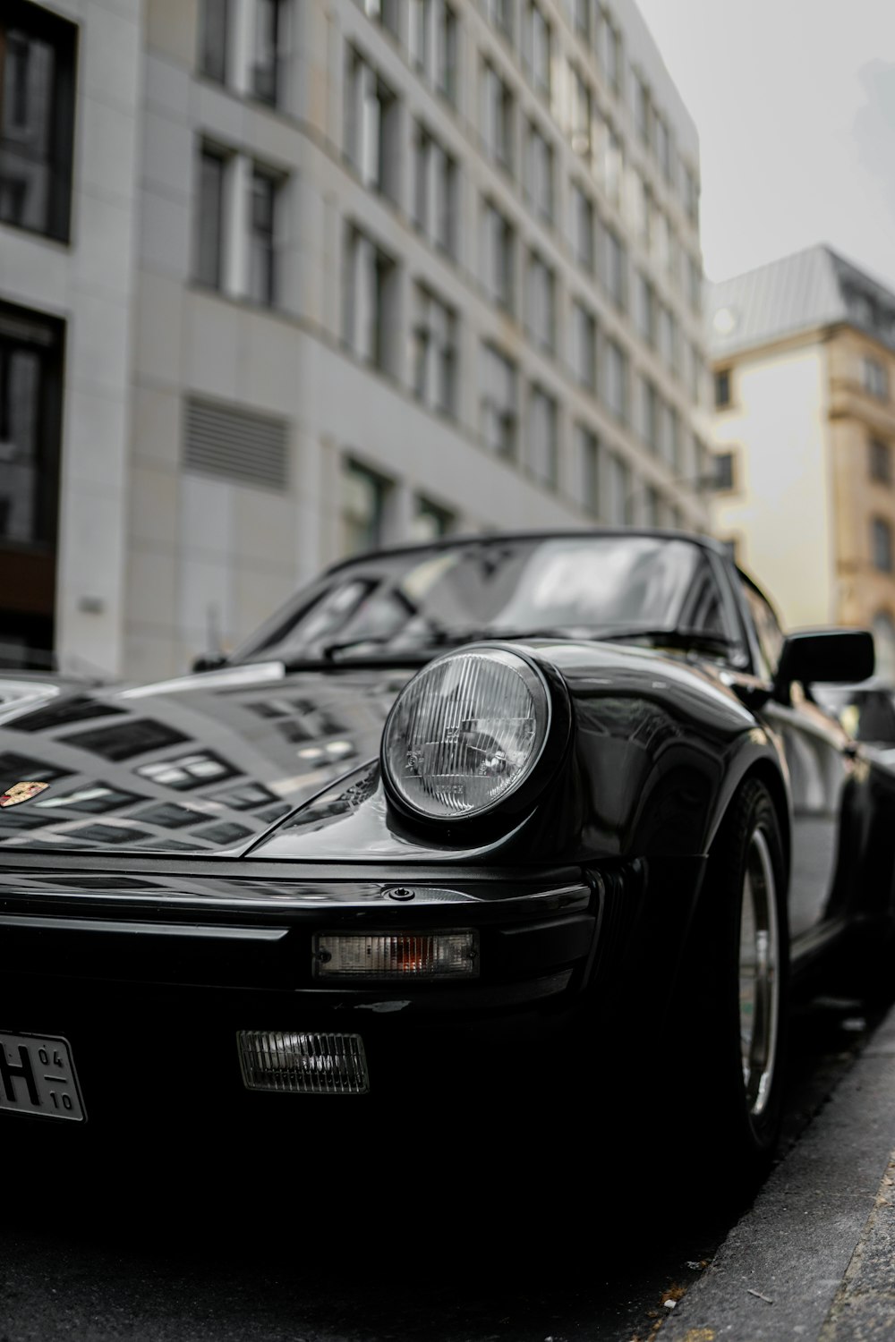 black porsche 911 parked near building during daytime