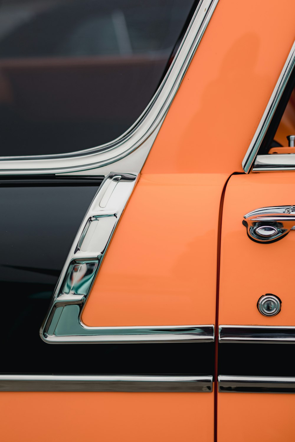 orange and silver car in a parking lot