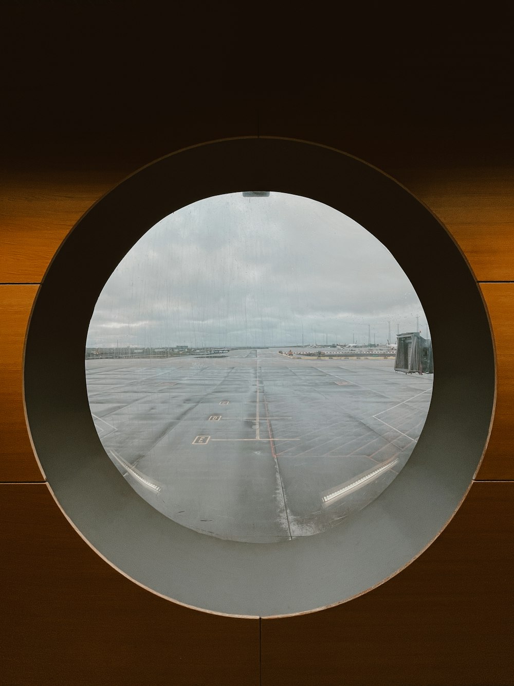 round mirror with brown wooden frame