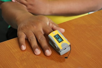 person holding white and blue plastic container