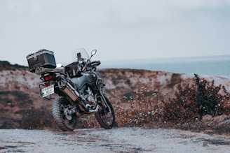 black motorcycle on brown field during daytime