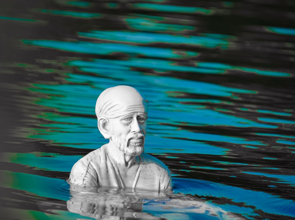 gray concrete statue of man in water