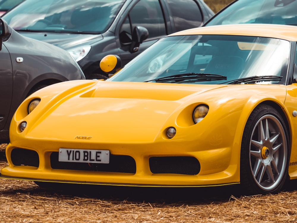 yellow porsche 911 parked on street during daytime