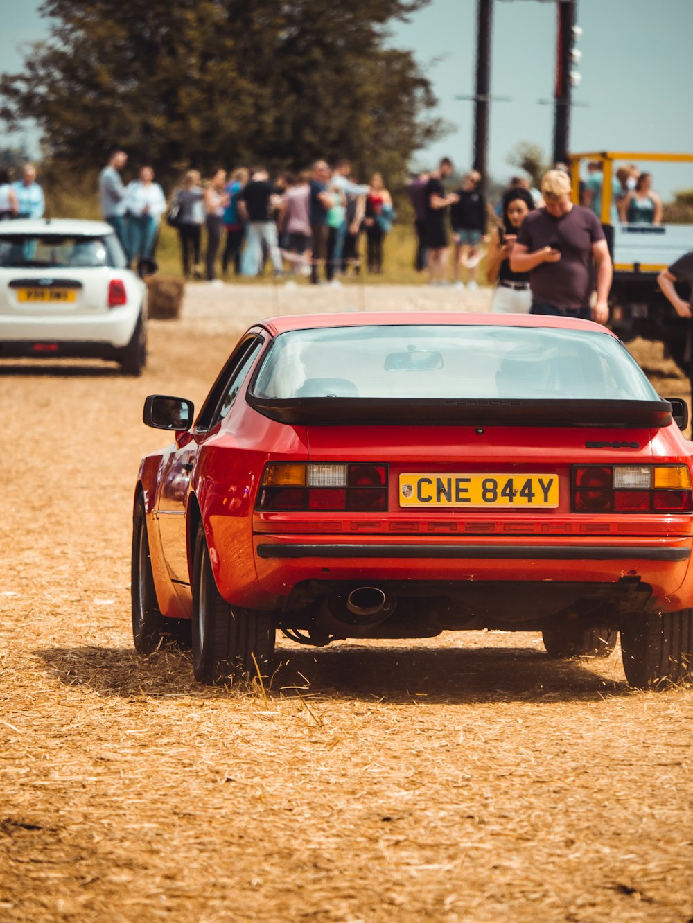 red chevrolet camaro on brown field during daytime