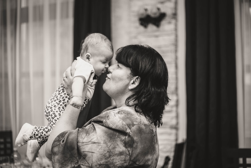 grayscale photo of woman kissing mans cheek