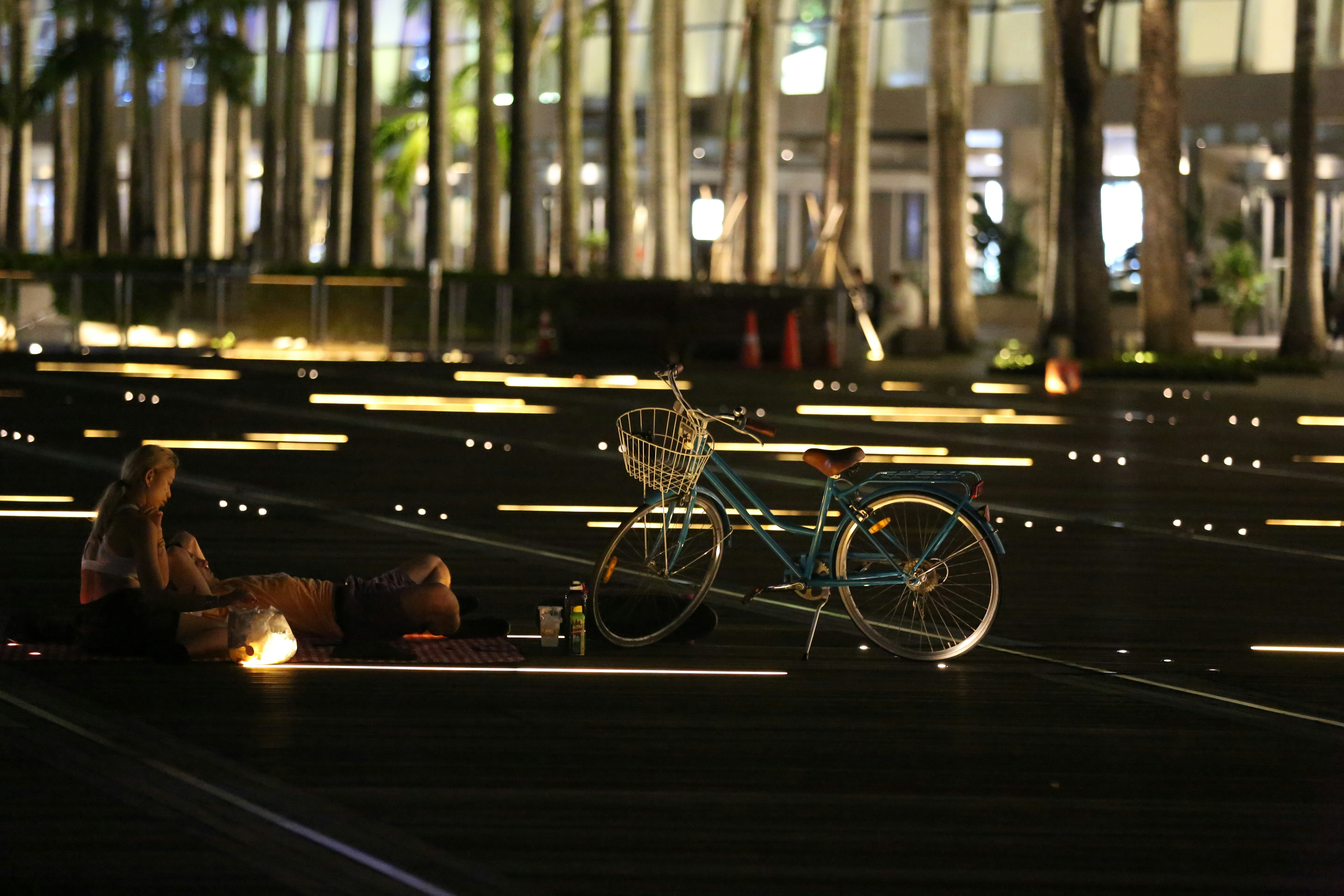 black bicycle parked on sidewalk during daytime