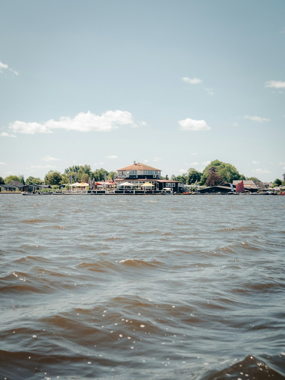 brown and white concrete building near body of water during daytime