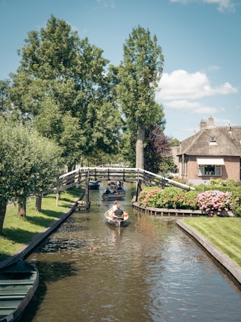 people riding on boat on river during daytime