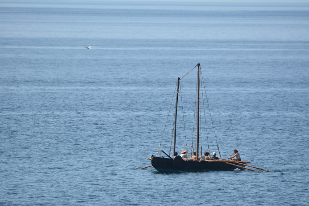 black boat on sea during daytime