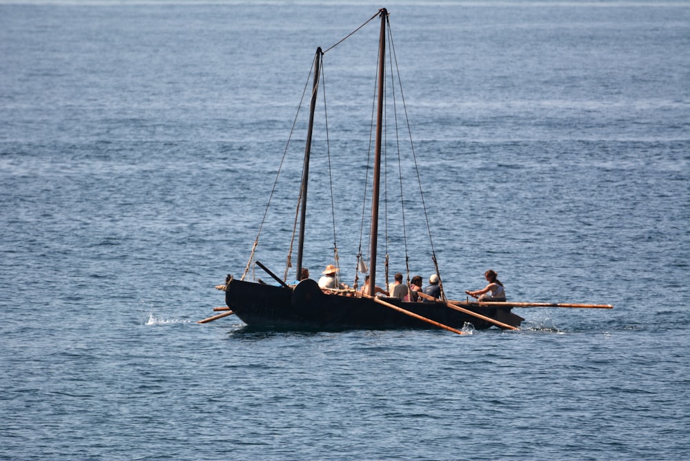 2 men riding on boat on sea during daytime