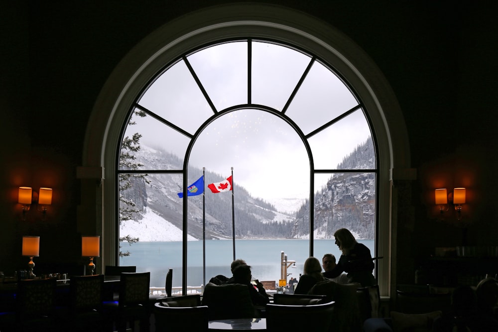 people sitting on chair near window during daytime