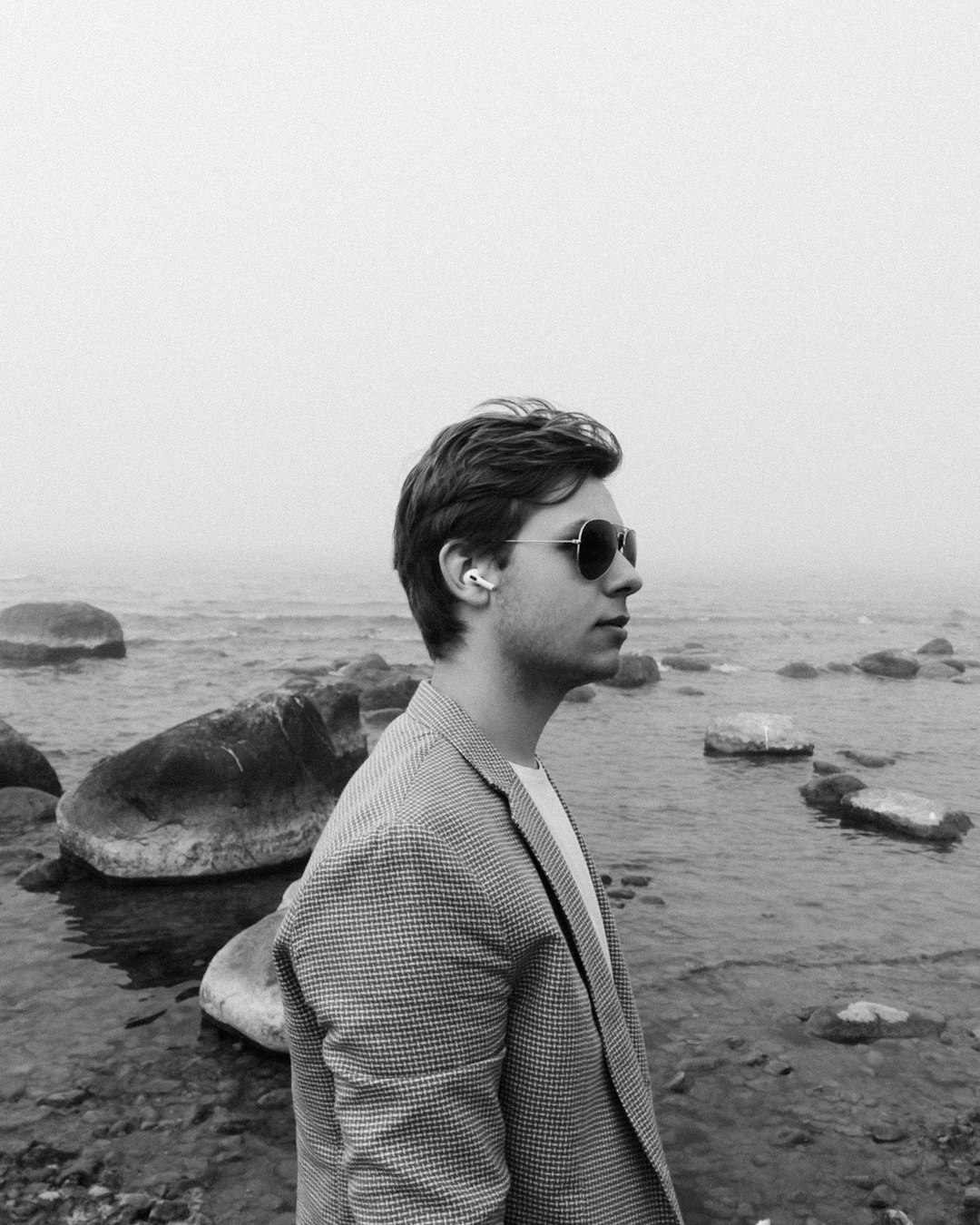 grayscale photo of woman in cardigan and sunglasses