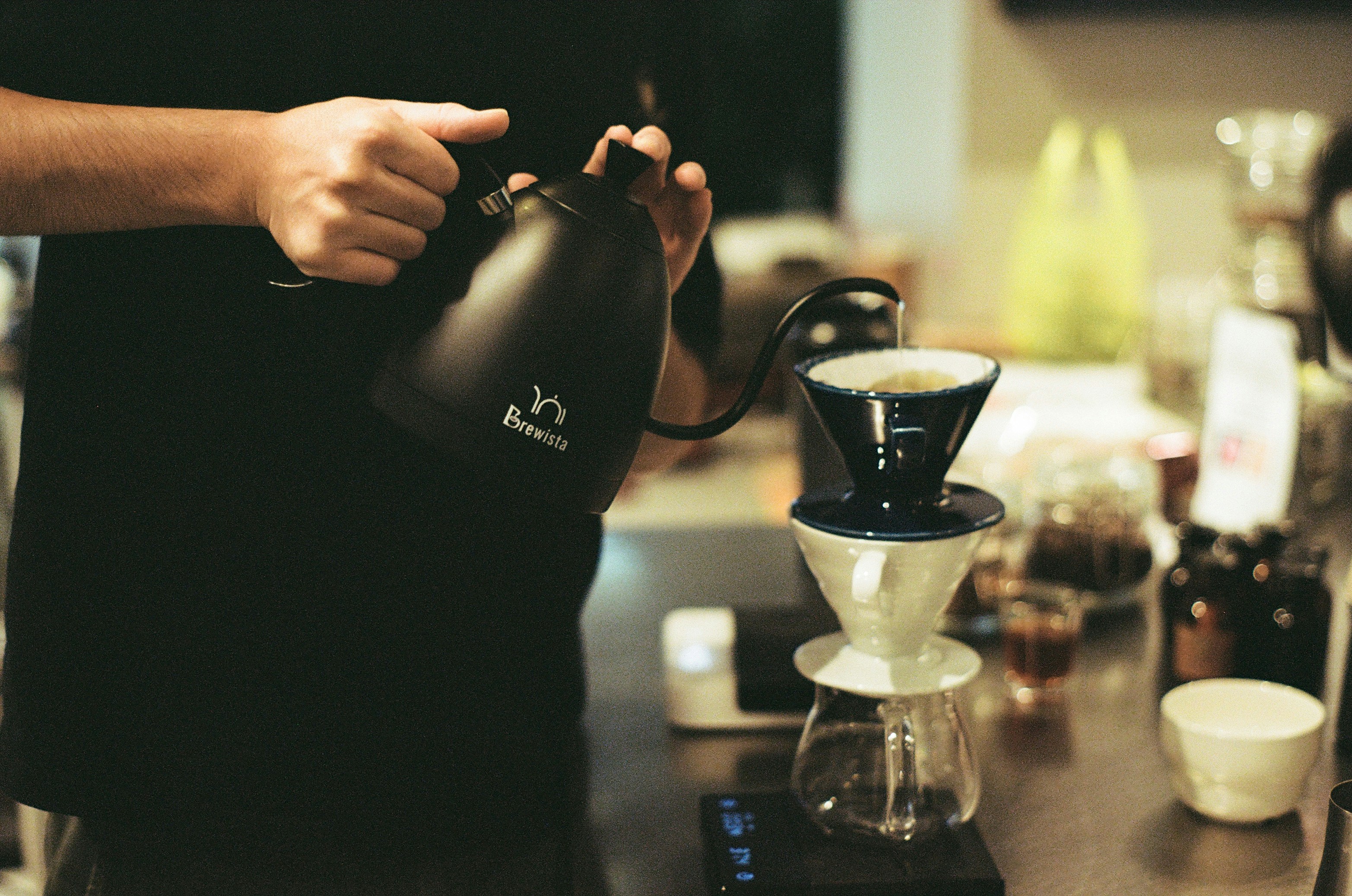 person holding black ceramic mug