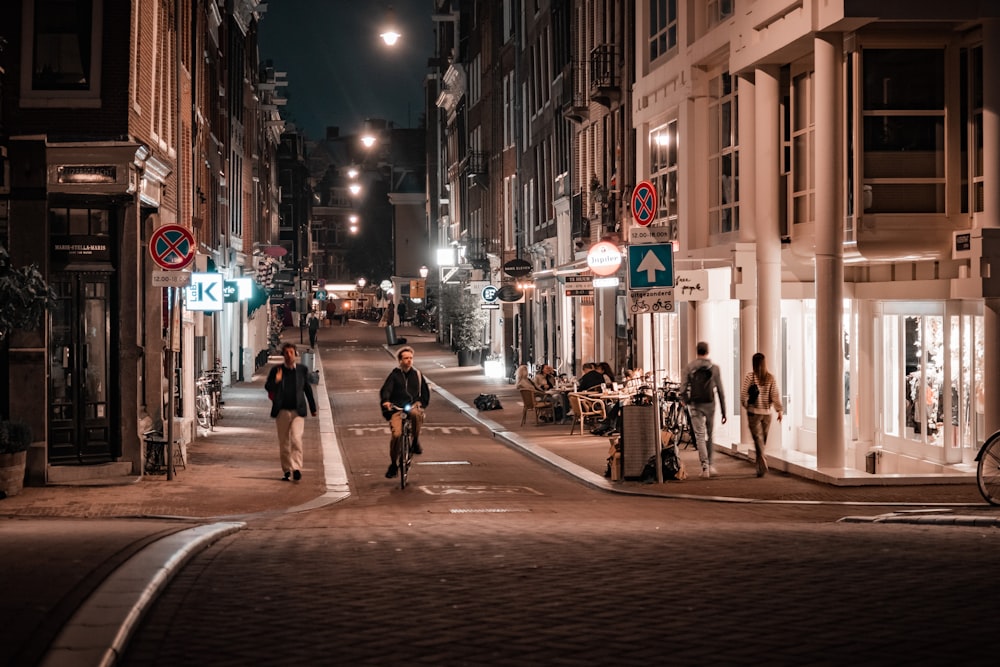 people walking on street during night time